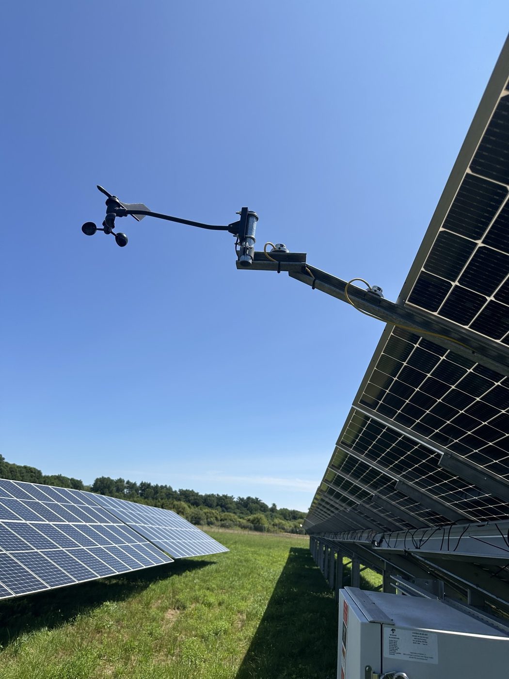 Weather station and irradiance sensor mounted beside a solar array