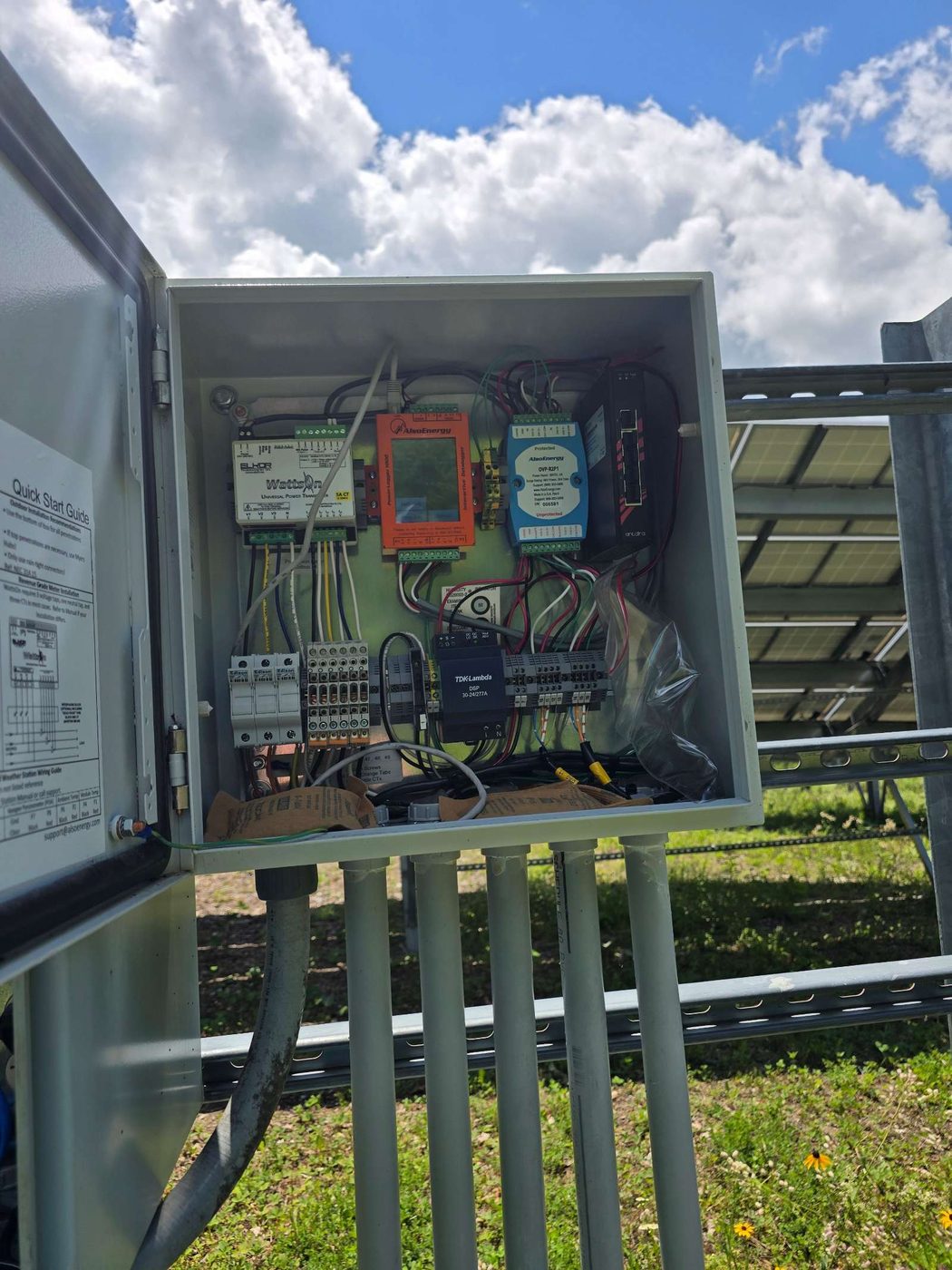 Monitoring cabinet opened for cleaning and inspection at the end of an array row